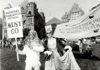 Mummy and 'Miss Management' lead protest, A mummy (Steven Spencer) and a garishly dressed woman calling herself 'Miss Management' (Rita Johnson) led R(...)
