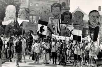 Heads up: Huge caricatures of the seven summit leaders, carried from Queen's Park rally, were later thrown on to a bonfire started to burn the American flag