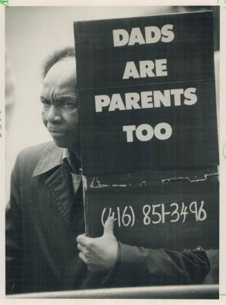 Parental rights: The sign says it all for Vere Cobham at a Queen's Park rally yesterday to demand changes in provincial law that would benefit estranged fathers