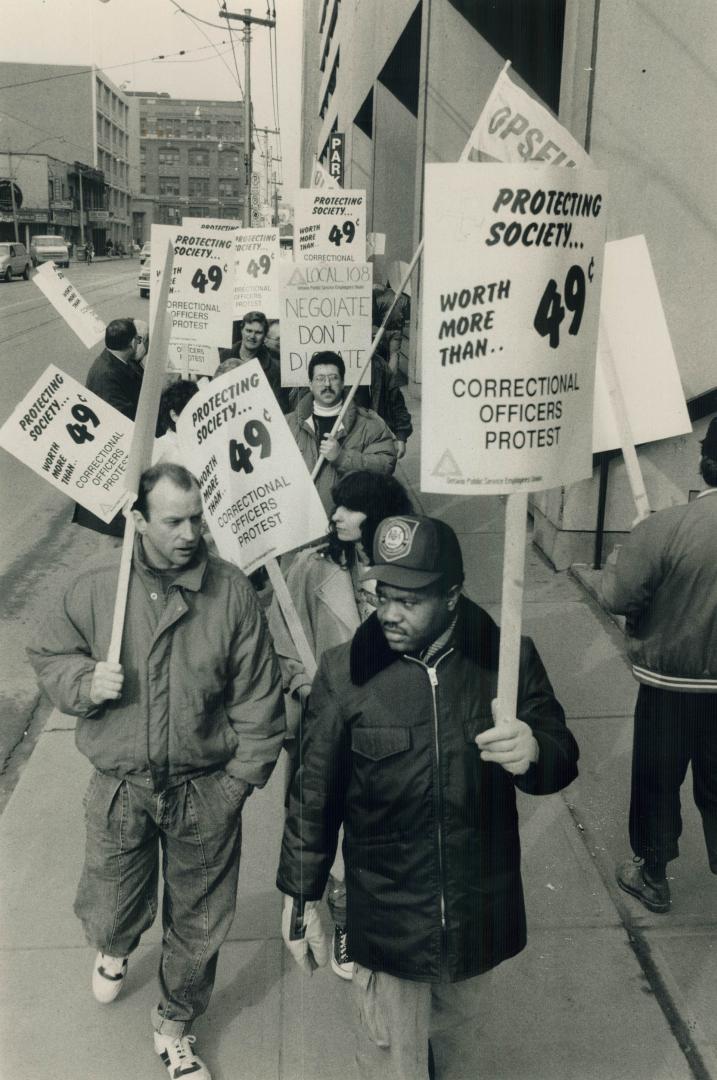 Guards demand better pensions, About 200 angry jail guards picket outside a downtown government building today in a protest over contract talks. The g(...)