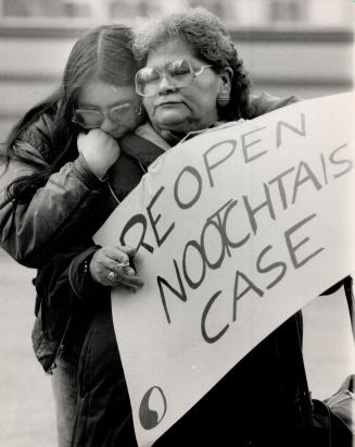 Protest march: Mabel Espaniel, carrying a sign, comforts Donna Nootchtai, sister of Virginia May Nootchtai, during a demonstration at Queen's Park yesterday