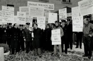 Placard protest: Air Canada pilot Ed Godin, with loudhailer, talks to fellow workers protesting aid for Canadian Airlines at Trade Minister Michael Wilson's constituency office in Toronto yesterday