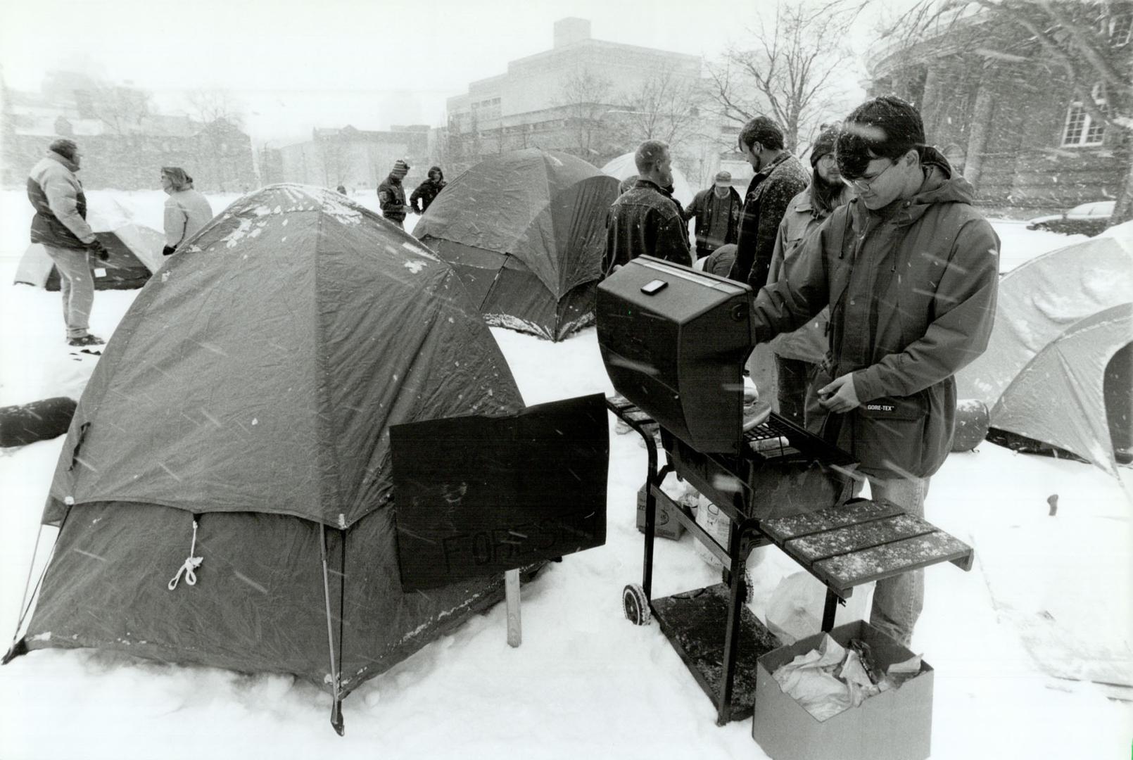 In-tents protest, Rod Marsh starts dinner during a 24-hour campout by about 20 forestry students at the University of Toronto to protest the univerity(...)