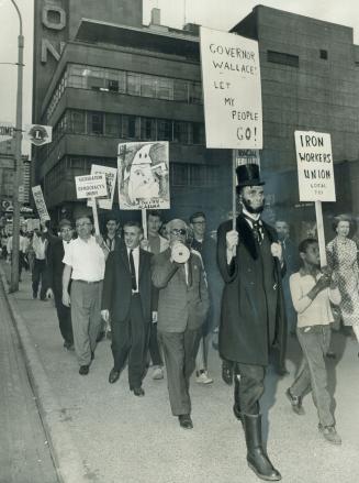 Protest: Lawyer David Lewis (left), Rabbi Abraham Feinberg, man dressed as Lincoln lead protest marchers outside Maple Leaf Gardens