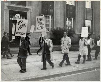 Parade of protest, Pickets hefted signs and paraded up and down outside the United States consulate on University Ave
