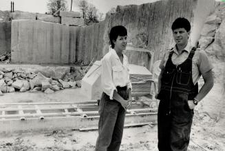 Treasure Trove: Sales agent Joanne Haliman and quarry chief Beven Ratcliffe stand in the Adair Marble Quarry, as a worker fits marble blocks on to a house in Torono's luxury Castle Hill development