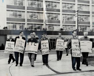 Pickets protest Negro's firing: Picketers march outside the Toronto Transit Commission's headquarters in support of an Ironworkers Local 721 call