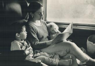 Riding in comfort: Miriam Greenberg reads to her children, Samuel, 3, and Jordana, 2, on VIA Rail's transcontinental train as the countryside of Muskoka races past a picture window
