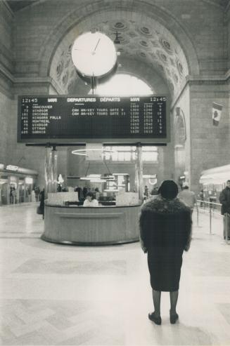 Time runs out: A woman surveys the departure times in Union Station yesterday during the countdown to oblivion for many VIA passenger trains across Canada