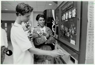 Recycling Fun, Students Derek Traimer, left, and Raju Patel feed cans into the Las Vegas-style slot machine that arrived at Vaughan Secondary school l(...)