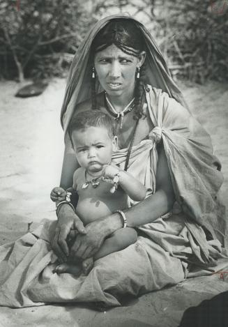 Mother in Mali sits on the sand when thousands fled from famine in the Sahel in 1974