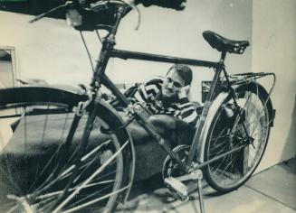 Ready to roll: Wolfgang Rugemer, 19, brought his bike with him from east Germany to west Berlin, where he lies ona bed at a red cross centre and mulls his future