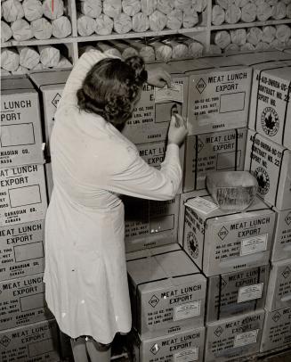 Cans of sausage, processed an packed in Canada, are being prepared for shipment to UNRRA