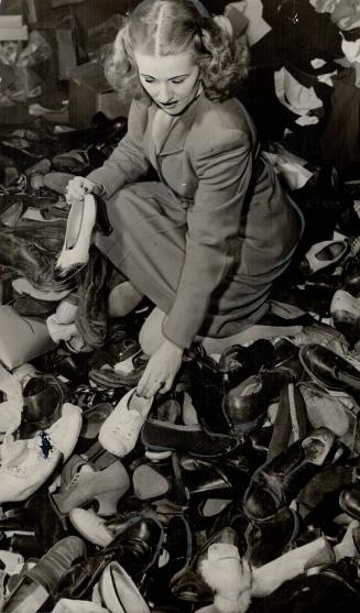 Servicemen sorting shoes would be saved many headaches and hours of work if contributors to the National Clothing Collection would take an extra minut(...)