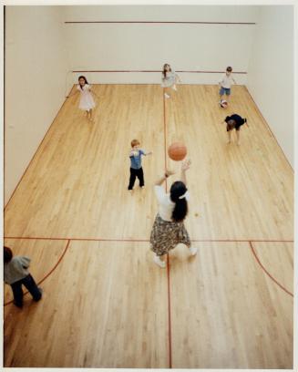 At play: Children take advantage of the home's indoor squash court to play a variety of games