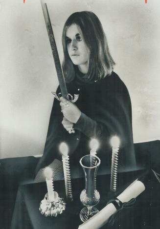 Sword, Scroll and Candles are basic part of the ritual fo Witch Kathi Byrne (at least, she hopes she is one), of Cooksville. The pretty 19-year-old ho(...)