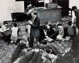 Children as well as adults crowd into the upper room for ardent, vocal prayer after the regular Sunday evening service at Toronto's Evangel Temple.Rev(...)