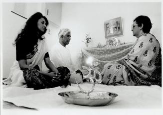 Deo Kernahan, centre, with wife Devi and daughter Dhristi, worships at the small shrine in his home, a common practice with many Hindus. But a new tem(...)