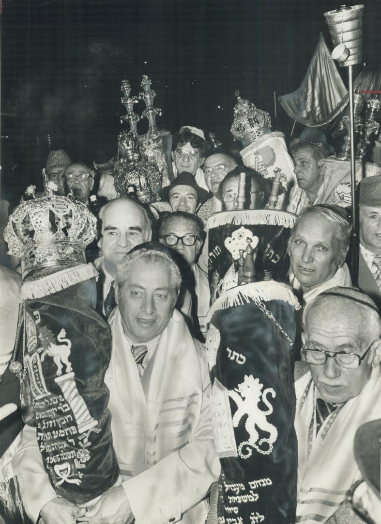 Synagogue transfers its Torahs, The Torahs, the Five Books of Moses hand-lettered on parchment, of the Hebrew Men of England are carried along Sheppar(...)