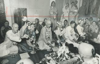 Triple wedding in Khrishna Temple, Behind a fire strewn with flowers and sprinkled with 10 different spices, Jagadisa Dasa Adhikary (bottom left) perf(...)