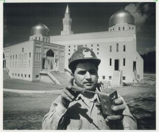 New Mosque nears completion, Electrician Muzafar Choudhary prepares an electrical outlet for instatllation into the Bait-Ul-Islam Mosque, owned by the(...)