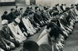 These Toronto Moslems kneel in prayer to celebrate the ascension of Mohamed to heaven and his return to earth 1,350 years ago. Prayers are a sacred ex(...)