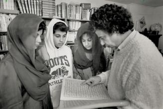Holy book: Abdul hameed Saifi, right, reads from the Koran to his wife Hamda and daughters Wara and Ryeha in their North York home
