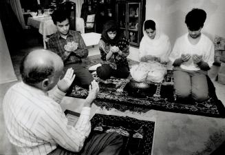 Two sides: Canadian Arabs and Muslims, like metro family above praying during gulf war, often found themselves at odds with some war sympathizers
