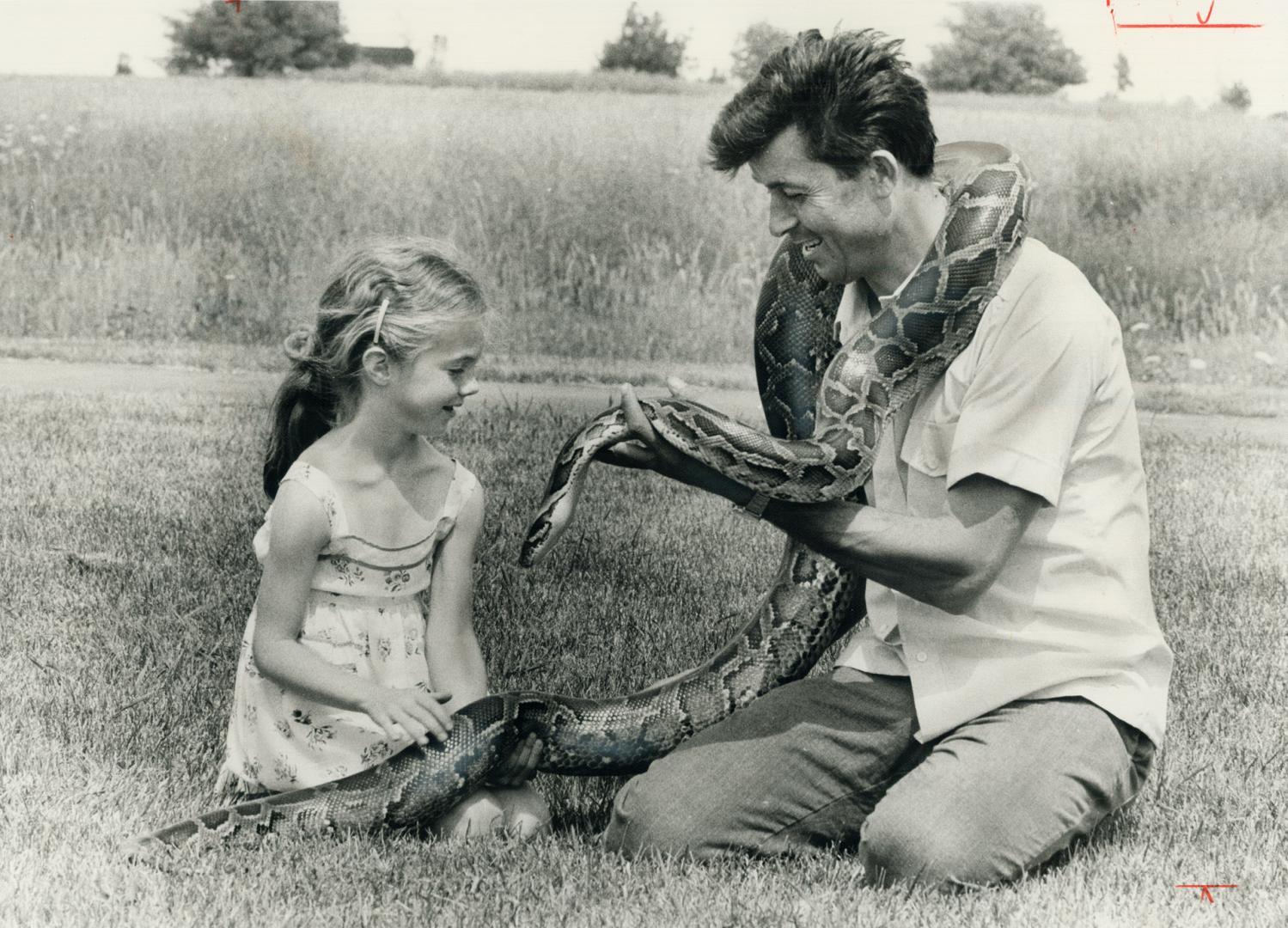 Great snakes alive! Jennifer DeGruchey, 6, seems somewhat lukewarm toward a boa constrictor being shown her by Sam Persi at Meadowvale Town Centre on (...)