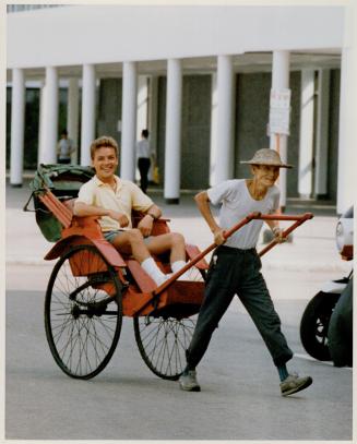 Above, humanpower, rather than horsepower, gets King around the streets of Hong Kong, where he has become an instant celebrity