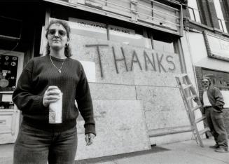 No thanks: Yonge St. merchants Marilyn and John Baker paint a sarcastic reply to rioters who broke a window in their shop on Monday
