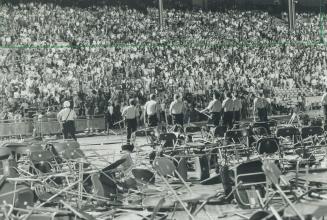 Alice Cooper fans threw scores of chairs on the Grandstand stage until police, sheilding themselves with chairs forced them back into stands