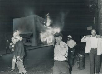 Looted store in the predominantly Negro Roxbury section of Boston goes up in flames last night in the wake of three days of rioting