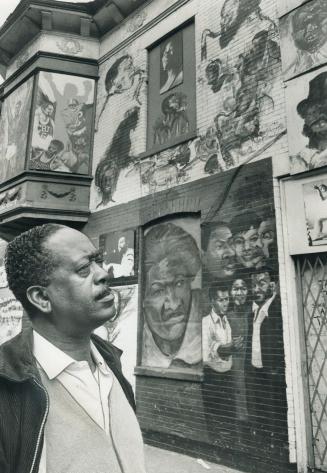 Chicago cabby Leroy Beauregard inspects Negro ghetto's Wall of Respect, painted by neighborhood art students last year in the city's south side