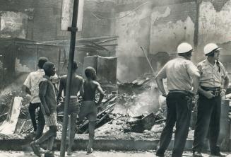 National Guardsmen restore an uneasy peace to riot-torn Cleveland, Negro district exploded into violence, destruction and looting for the second night in a row