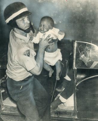 Cleveland policeman lifts baby from shot-up car, He had crease across neck from bullet and was taken to hospital
