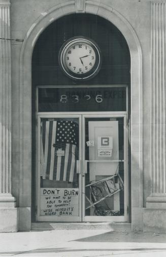 'Don't burn us'. This is the agony of riot-torn Detorit, mirrored in the glass door of a Negro-owned bank where a hastily scrawled sign pleads to be s(...)