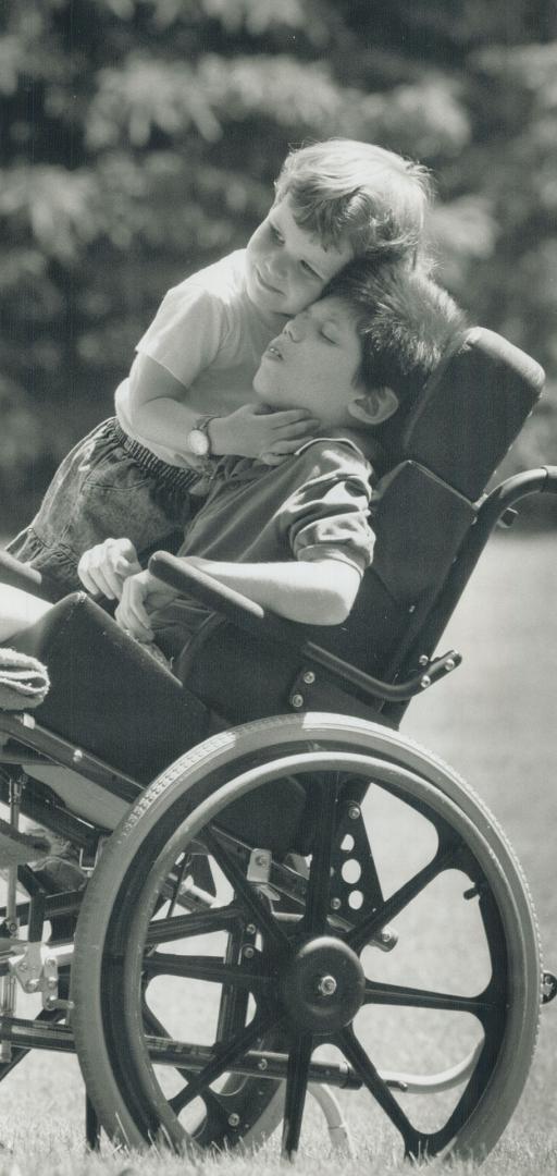 Anthony Wright, 11, gets a hug from his sister Angela, 2, who will be able to visit him often in his new home