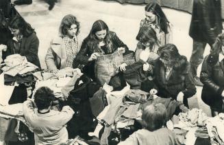 Bargain-hunters flock to a table load of jeans and pants at the Hadassah bazaar today in Exhibition Park, the world's largest one-day rummage sale. Ab(...)