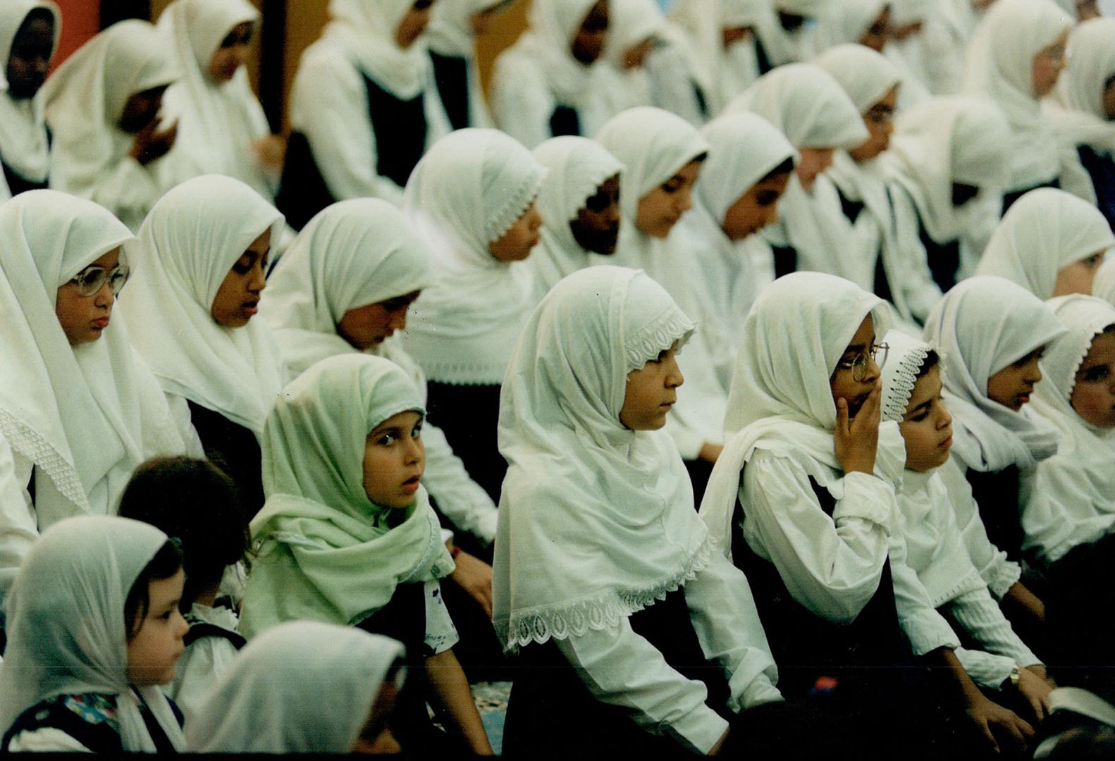 Identity: Girls wearing traditional hijab pray in the gym at ISNA-Islamic school in Mississauga