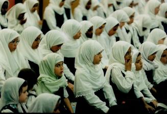 Identity: Girls wearing traditional hijab pray in the gym at ISNA-Islamic school in Mississauga