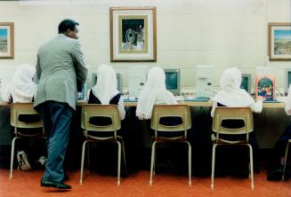 New ways: Students at the ISNa-Islamic school wear traditional clothes but get modern training on computers