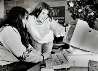 Fresh start: Enrolees Becky Watson, 20, and Laurie Dale, 19, (standing) check the computer listings at special program for unemployed or underemployed high school dropouts at Port Perry High School