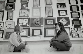 Wall of talent, Amanada Roberts, 9, and 8-year-old Giselle Mathieu, right, both of Father Joseph Venini School, enjoy Art to Art Talk, an exhibition o(...)
