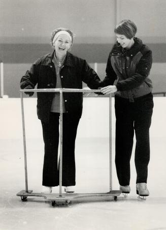 Gliding light: Janina Krajewski, 65, (left) gets a skating lesson from Lisa de Candida as part of a prgoram for seniors presented by the North York parks and recreation department
