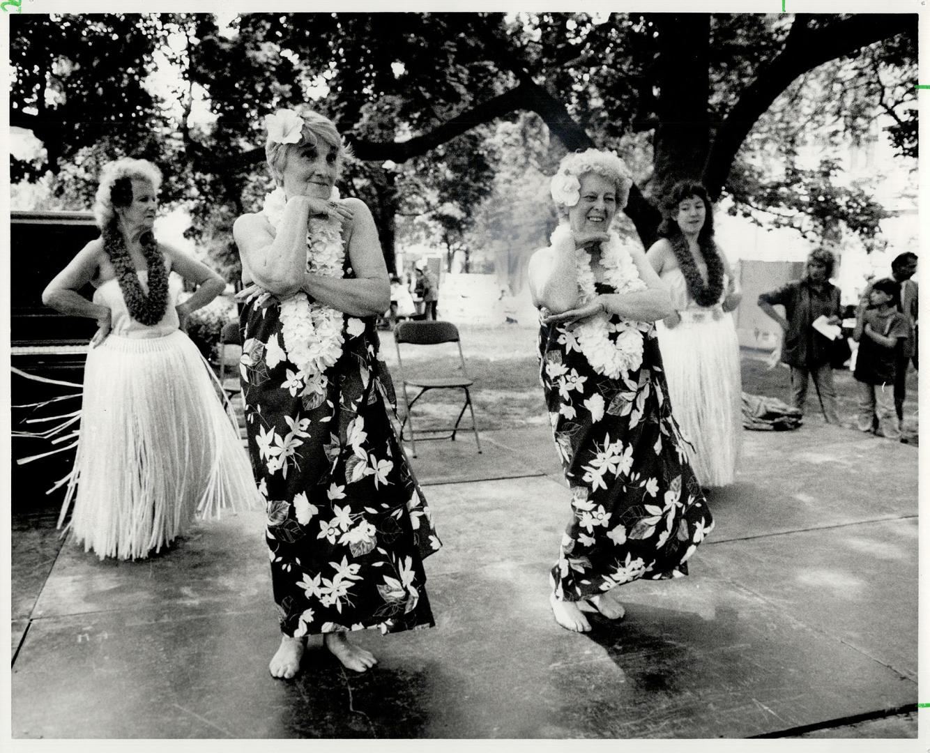 Hula dancers hold sway at seniors' fair, The Haoles Hawaiian dance group, left, captivates some of the seniors in the audience, right, at the Seniors'(...)