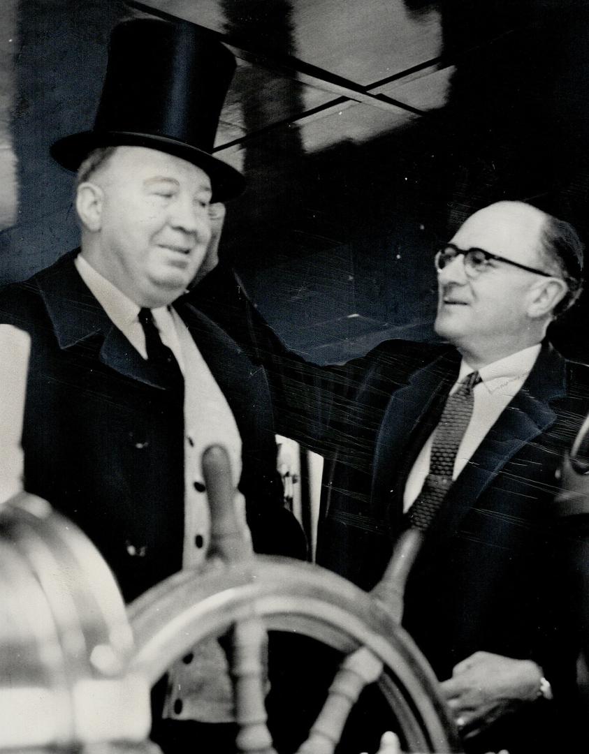 First skippers. Captain Walker MacMillan of the Wave Transport receives top hat from Harbormaster H.J. Snelgrove for being first ship into Port of Toronto for 1961 shipping season