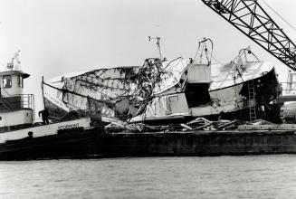 The bodies of three fishermen were found early today in the mangled wreck of the Captain K, Left, which was raised from Lake Erie yesterday. The smelt(...)