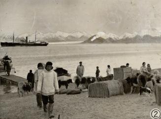 Supplies being landed from the Nascopie which is seen in the left background