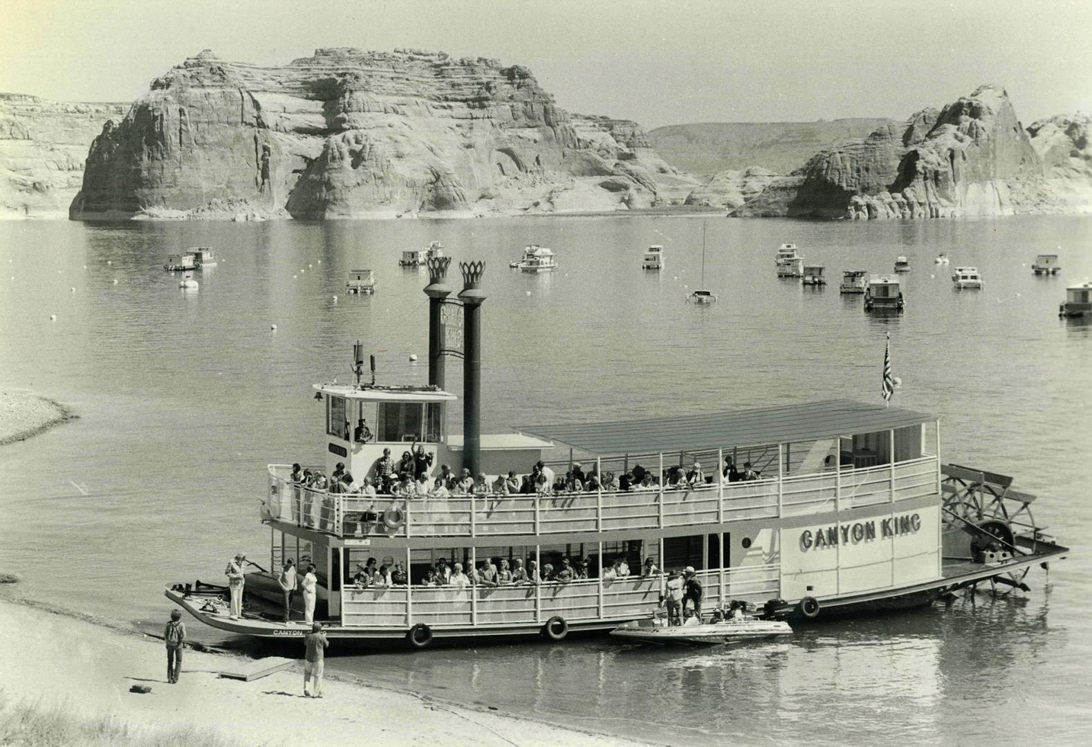 The paddle-wheeler Canyon King unloads passengers on the shores of Lake Powell, a man-made ocean that gleams like a blue jewel amidst the red rock of Arizona